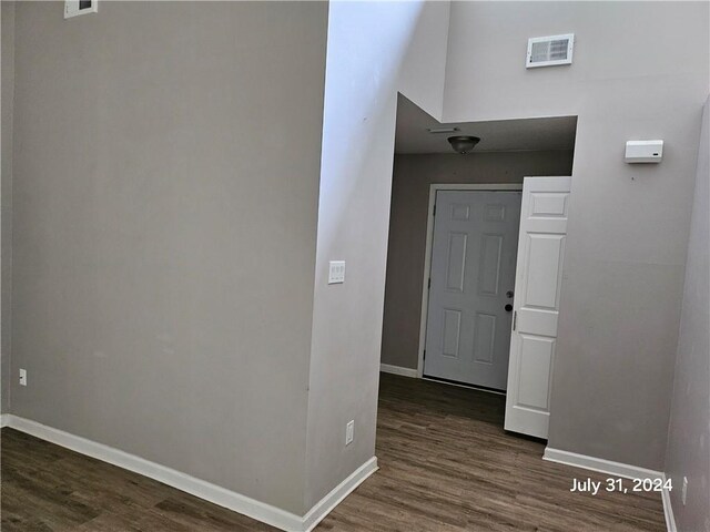 hallway with dark hardwood / wood-style flooring