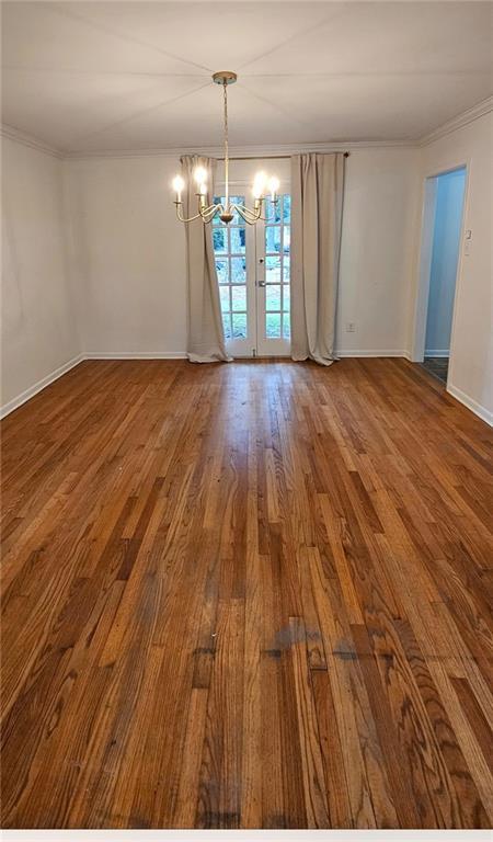 159 Conway Dr W, Mobile, AL 36608 - unfurnished dining area with a chandelier, wood finished floors, crown molding, and baseboards
