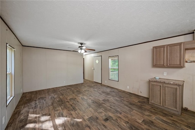 6550 Oak Grove Rd, Eight Mile, AL 36613 - unfurnished living room with dark wood finished floors, ceiling fan, a textured ceiling, and crown molding