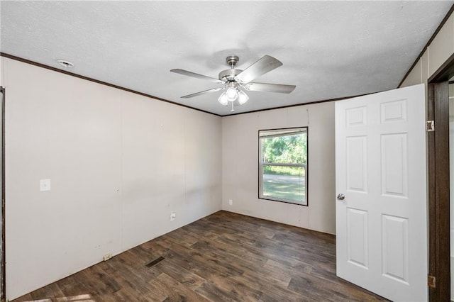 6550 Oak Grove Rd, Eight Mile, AL 36613 - spare room with dark wood finished floors, a ceiling fan, a textured ceiling, and ornamental molding