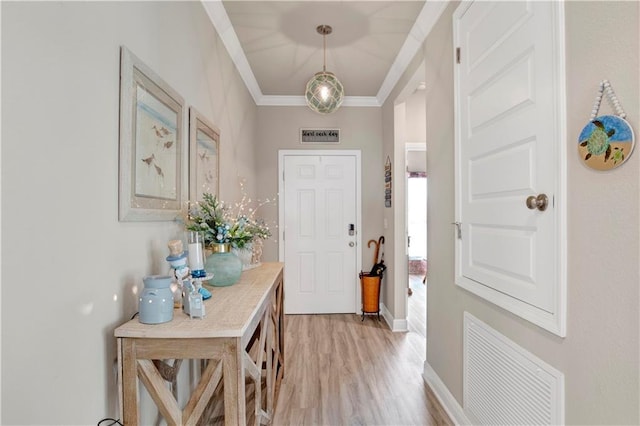 interior space with crown molding and light wood-type flooring