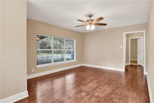 unfurnished room featuring ceiling fan and dark hardwood / wood-style floors