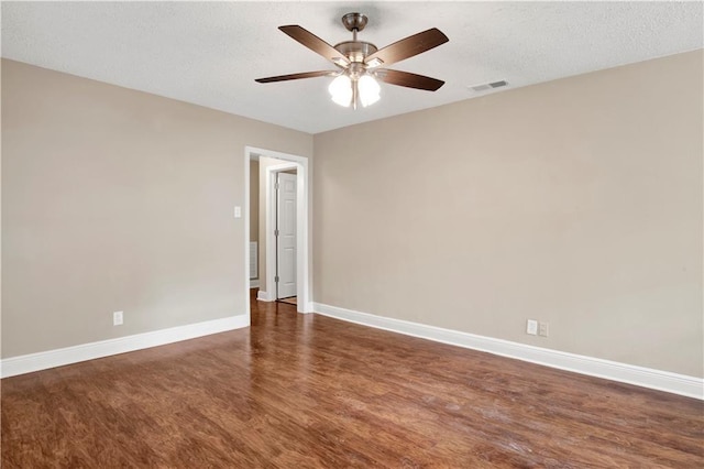 unfurnished room featuring ceiling fan and dark wood-type flooring