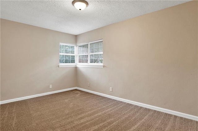 unfurnished room featuring a textured ceiling and carpet flooring