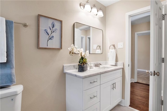 bathroom with toilet and vanity