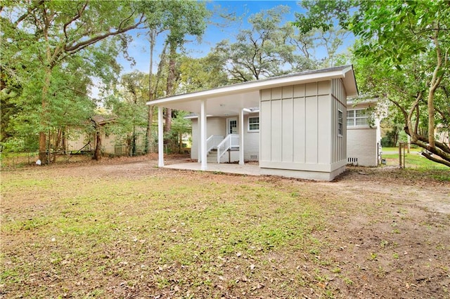 rear view of property with a yard