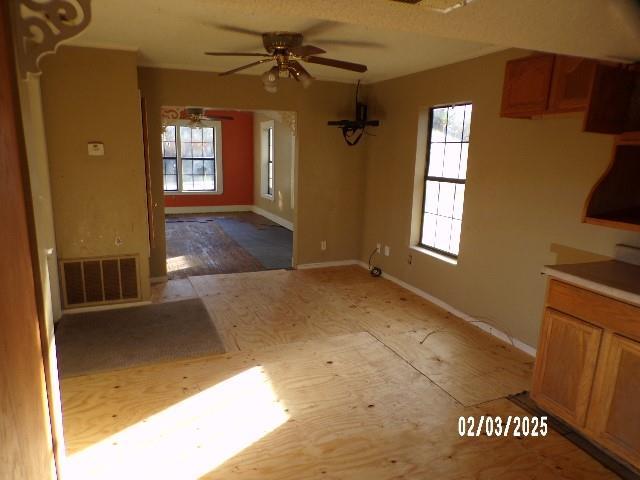 unfurnished dining area with a wealth of natural light and ceiling fan