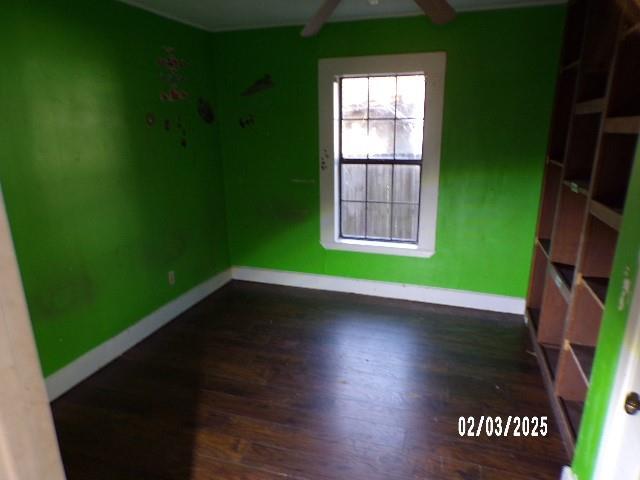 spare room with dark hardwood / wood-style floors and ceiling fan