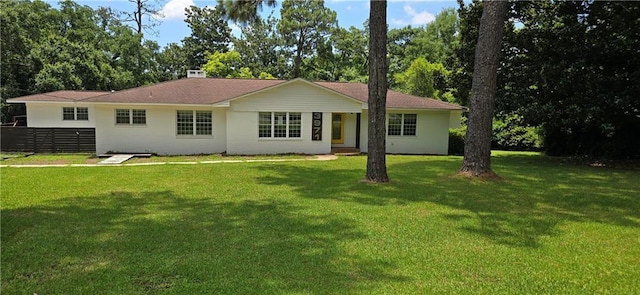 back of house featuring a lawn