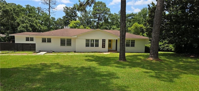 back of property featuring a lawn