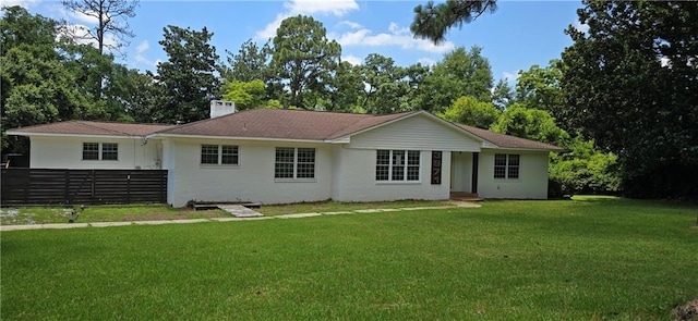 rear view of property with a yard