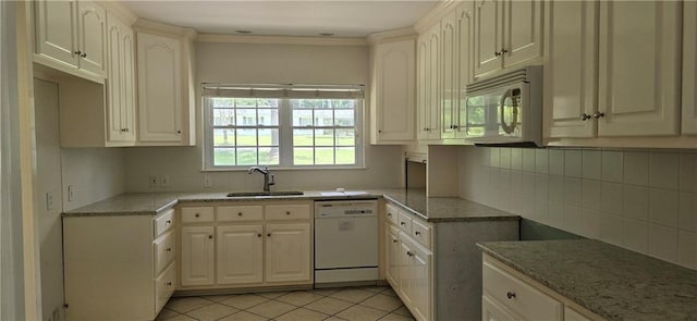 kitchen featuring sink, white appliances, white cabinetry, light stone counters, and light tile patterned flooring