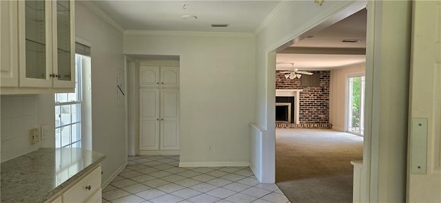 hallway featuring crown molding and light carpet