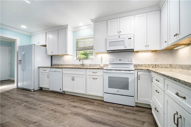 17714 Horseneck Rd, Bay Minette, AL 36507 - kitchen featuring crown molding, white appliances, decorative backsplash, and white cabinets