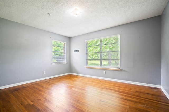 17714 Horseneck Rd, Bay Minette, AL 36507 - spare room with baseboards, a textured ceiling, and wood finished floors