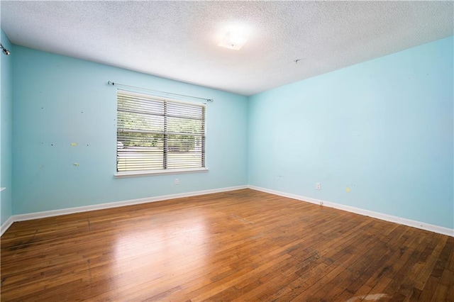 17714 Horseneck Rd, Bay Minette, AL 36507 - empty room with a textured ceiling, wood-type flooring, and baseboards