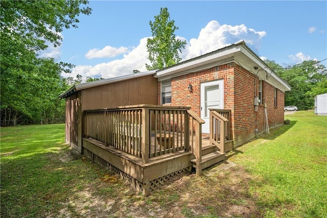 17714 Horseneck Rd, Bay Minette, AL 36507 - rear view of house with a wooden deck, brick siding, and a lawn