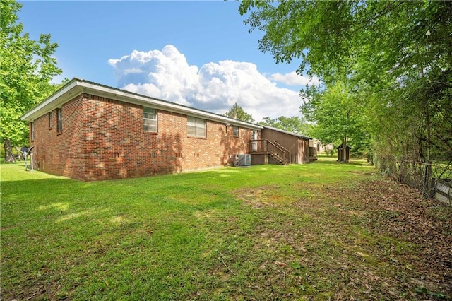 17714 Horseneck Rd, Bay Minette, AL 36507 - view of side of property with central AC, fence, brick siding, and a lawn