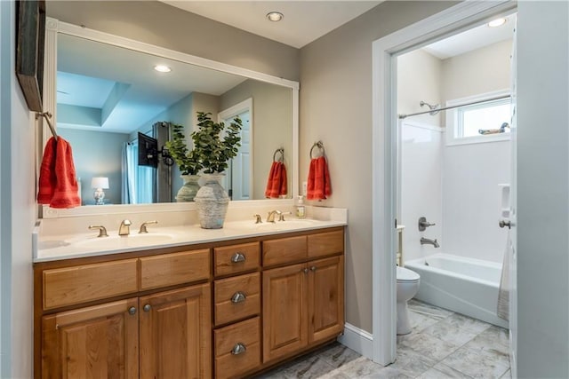 full bathroom featuring vanity, toilet, and washtub / shower combination