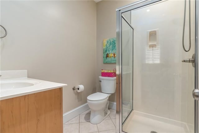 bathroom featuring vanity, a shower with door, tile patterned floors, and toilet