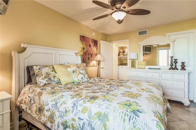 bedroom with ceiling fan and light tile patterned flooring