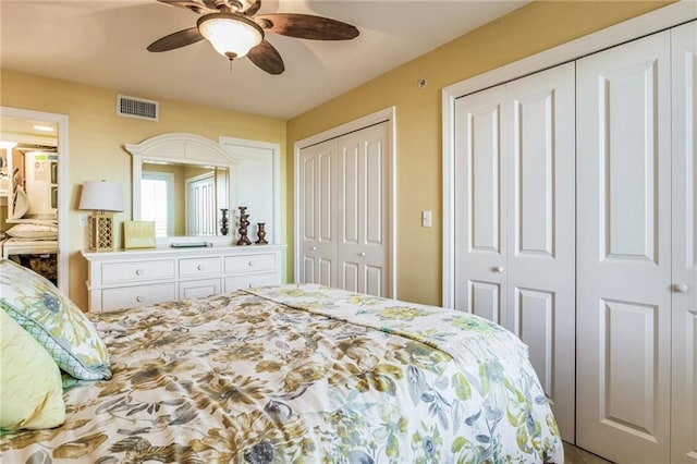 bedroom with two closets and ceiling fan