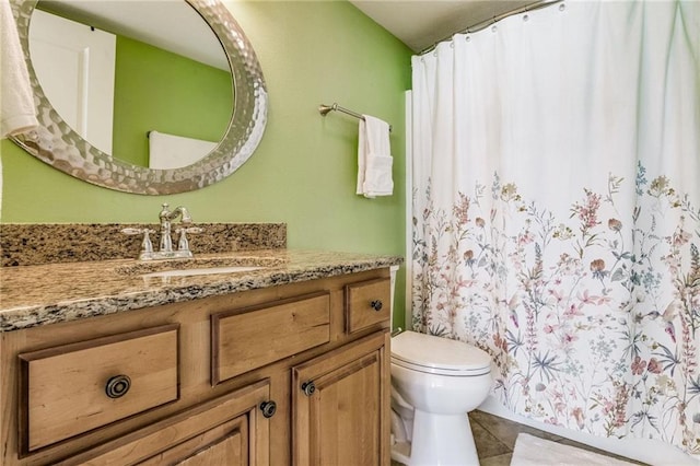 bathroom featuring tile patterned floors, vanity, and toilet