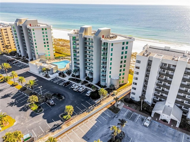 bird's eye view with a water view and a beach view