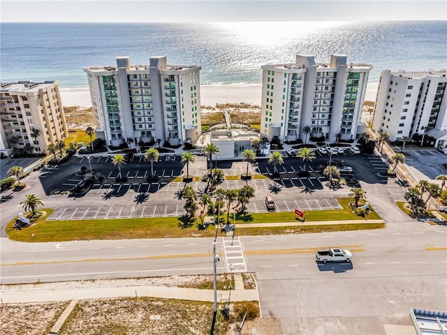 bird's eye view with a water view and a beach view