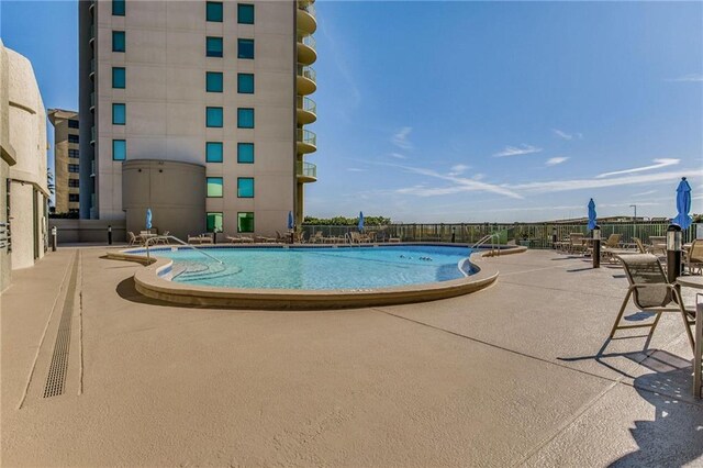 view of swimming pool with a patio