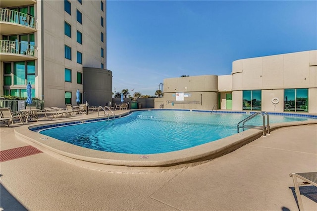 view of swimming pool featuring a patio area