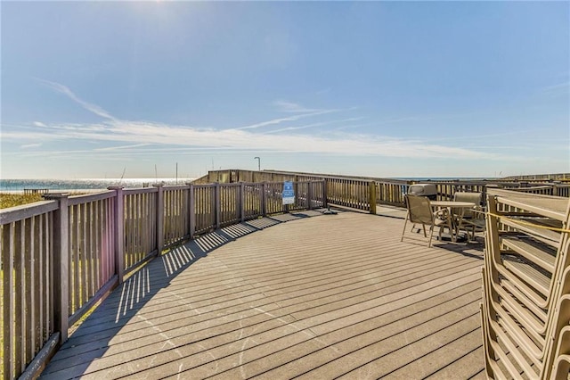 wooden terrace featuring a water view