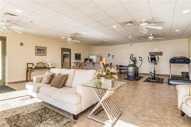 tiled living room featuring a drop ceiling