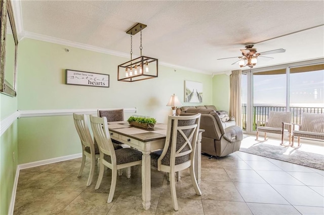 dining space featuring ceiling fan, light tile patterned floors, a textured ceiling, and ornamental molding