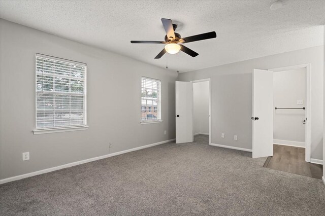 unfurnished bedroom featuring carpet flooring, a textured ceiling, and ceiling fan