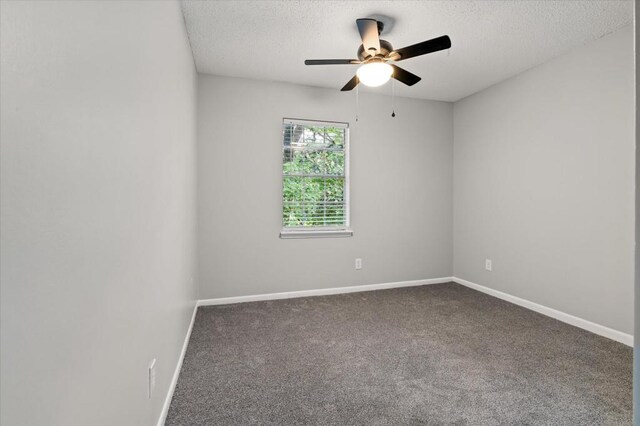 carpeted spare room with ceiling fan and a textured ceiling