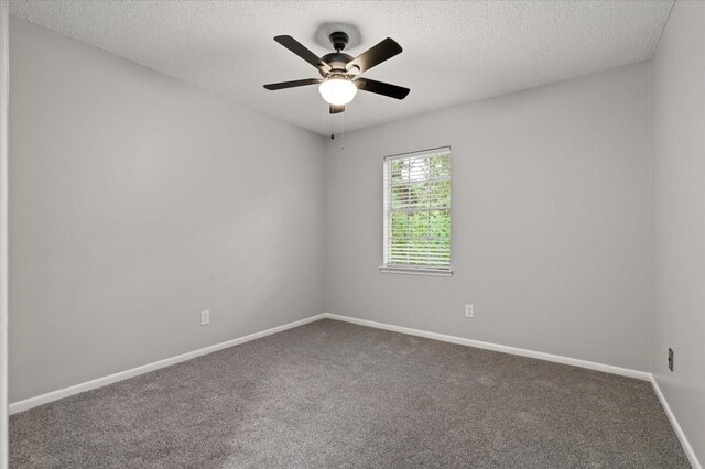 unfurnished room featuring a textured ceiling, carpet floors, and ceiling fan