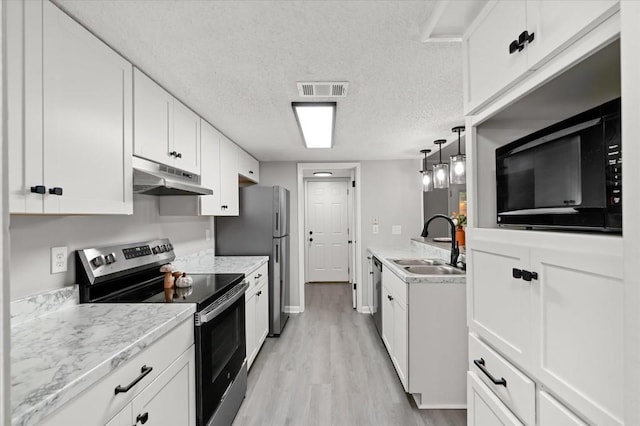 kitchen with sink, stainless steel appliances, light hardwood / wood-style flooring, a textured ceiling, and white cabinets