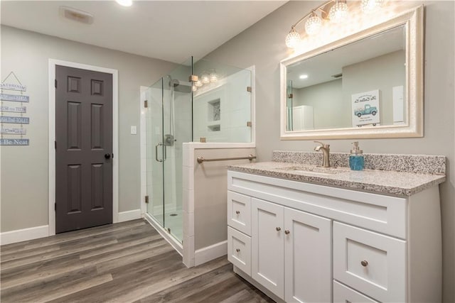 11375 Wacker Dr, Theodore, AL 36582 - bathroom featuring vanity, a stall shower, and wood finished floors