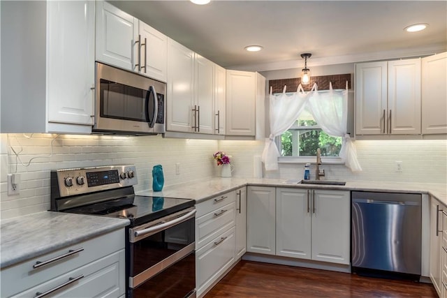 11375 Wacker Dr, Theodore, AL 36582 - kitchen with stainless steel appliances, tasteful backsplash, white cabinets, dark wood-type flooring, and recessed lighting