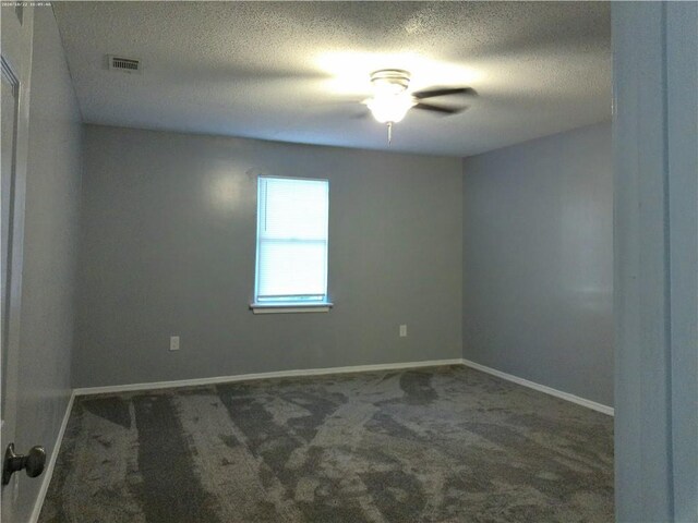 carpeted spare room with a textured ceiling and ceiling fan