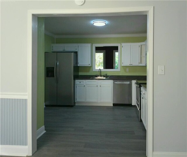 kitchen featuring white cabinetry, appliances with stainless steel finishes, sink, and dark hardwood / wood-style flooring