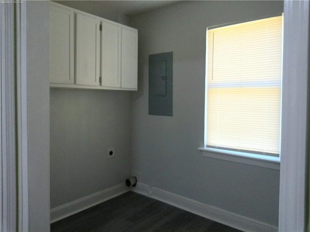 laundry area featuring electric panel, electric dryer hookup, dark hardwood / wood-style floors, and cabinets