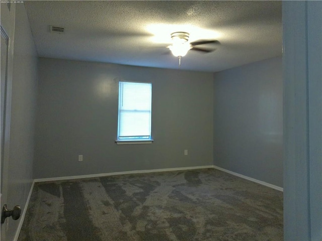 carpeted empty room featuring ceiling fan and a textured ceiling