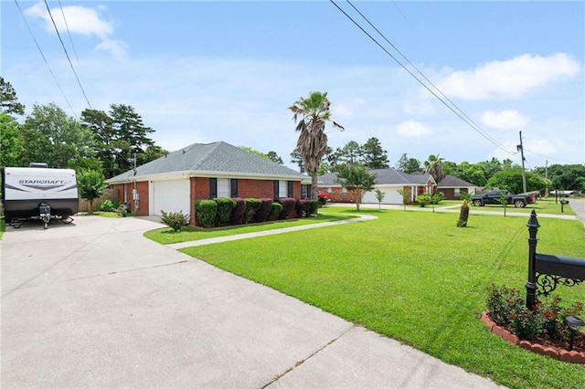 7115 Haleys Way, Theodore, AL 36582 - view of front facade featuring driveway, a front yard, brick siding, and a garage