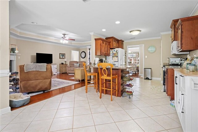 7115 Haleys Way, Theodore, AL 36582 - kitchen featuring ornamental molding, white appliances, light tile patterned flooring, a ceiling fan, and open floor plan