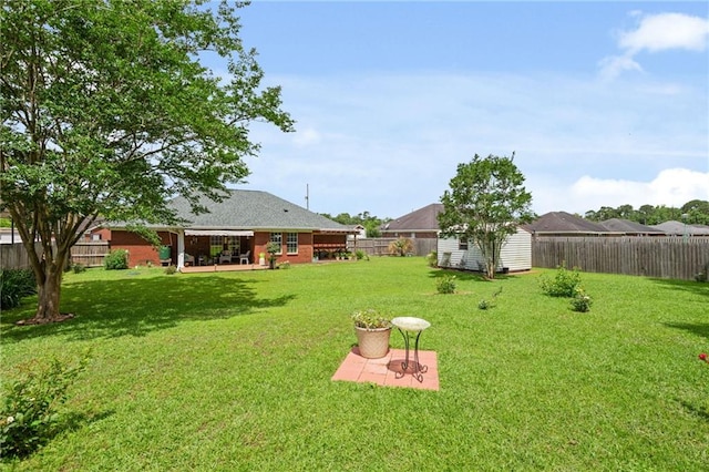 7115 Haleys Way, Theodore, AL 36582 - view of yard featuring an outdoor structure, a storage shed, and a patio area