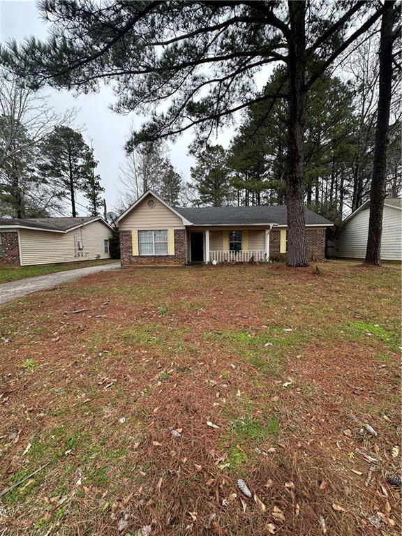 single story home with a front yard and brick siding