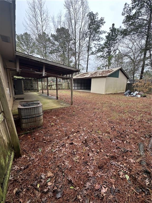 view of yard featuring an outbuilding and central AC