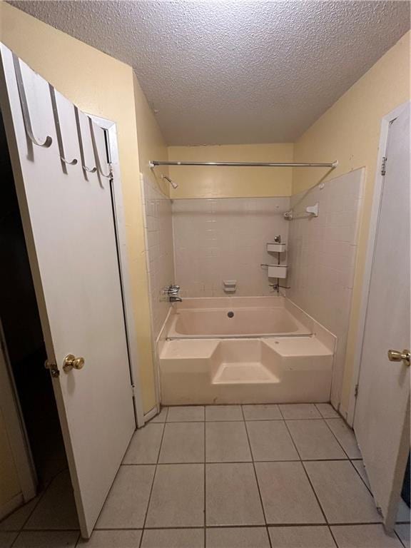 bathroom featuring bathtub / shower combination, a textured ceiling, and tile patterned floors